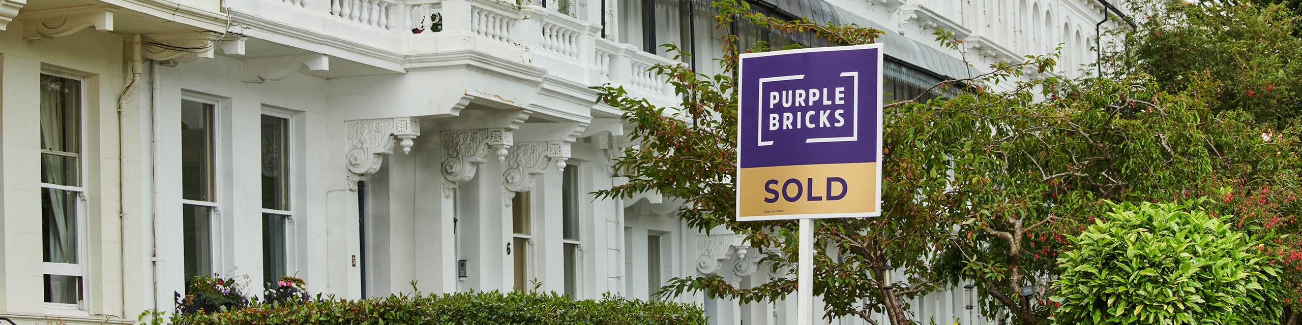  A Purplebricks sold board outside a house - Purplebricks estate agents
